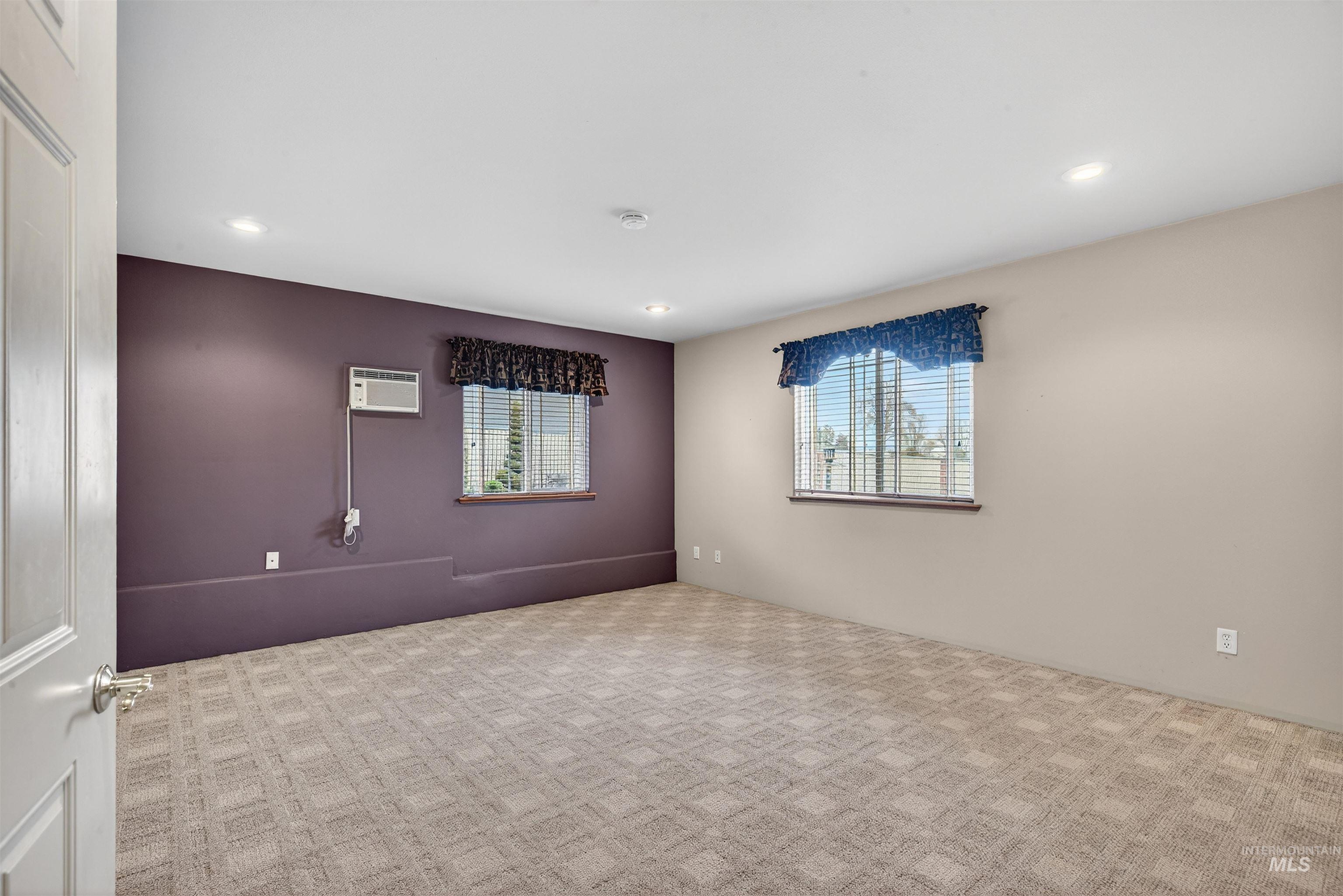 1324 Setlow Court Clarkston, WA 99403 - Photo 26 of 49 Spare room featuring plenty of natural light, carpet flooring, recessed lighting, and a wall unit AC
