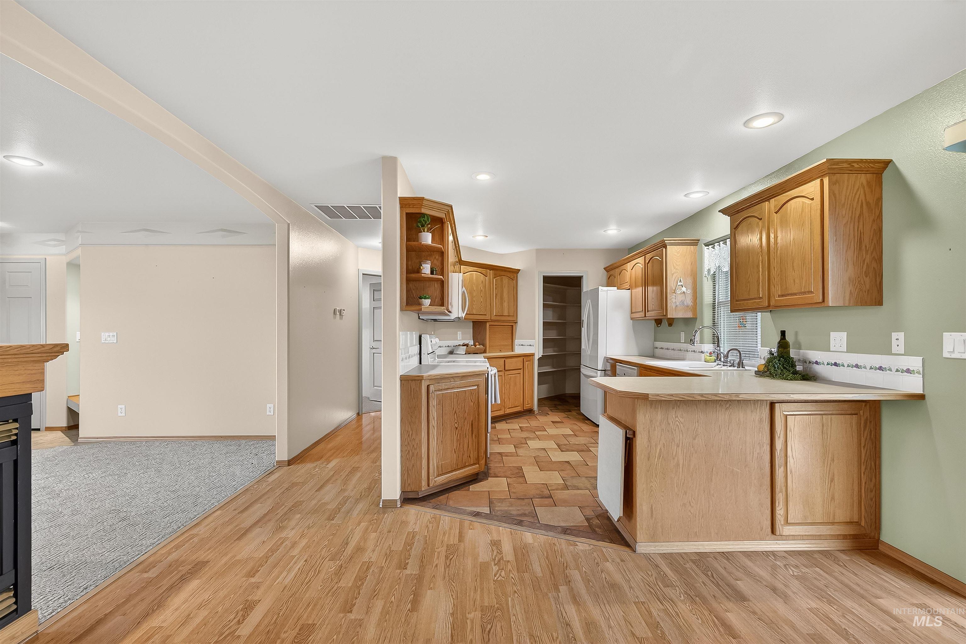 1324 Setlow Court Clarkston, WA 99403 - Photo 28 of 49 Kitchen with light countertops, a peninsula, open shelves, light wood-style floors, and recessed lighting