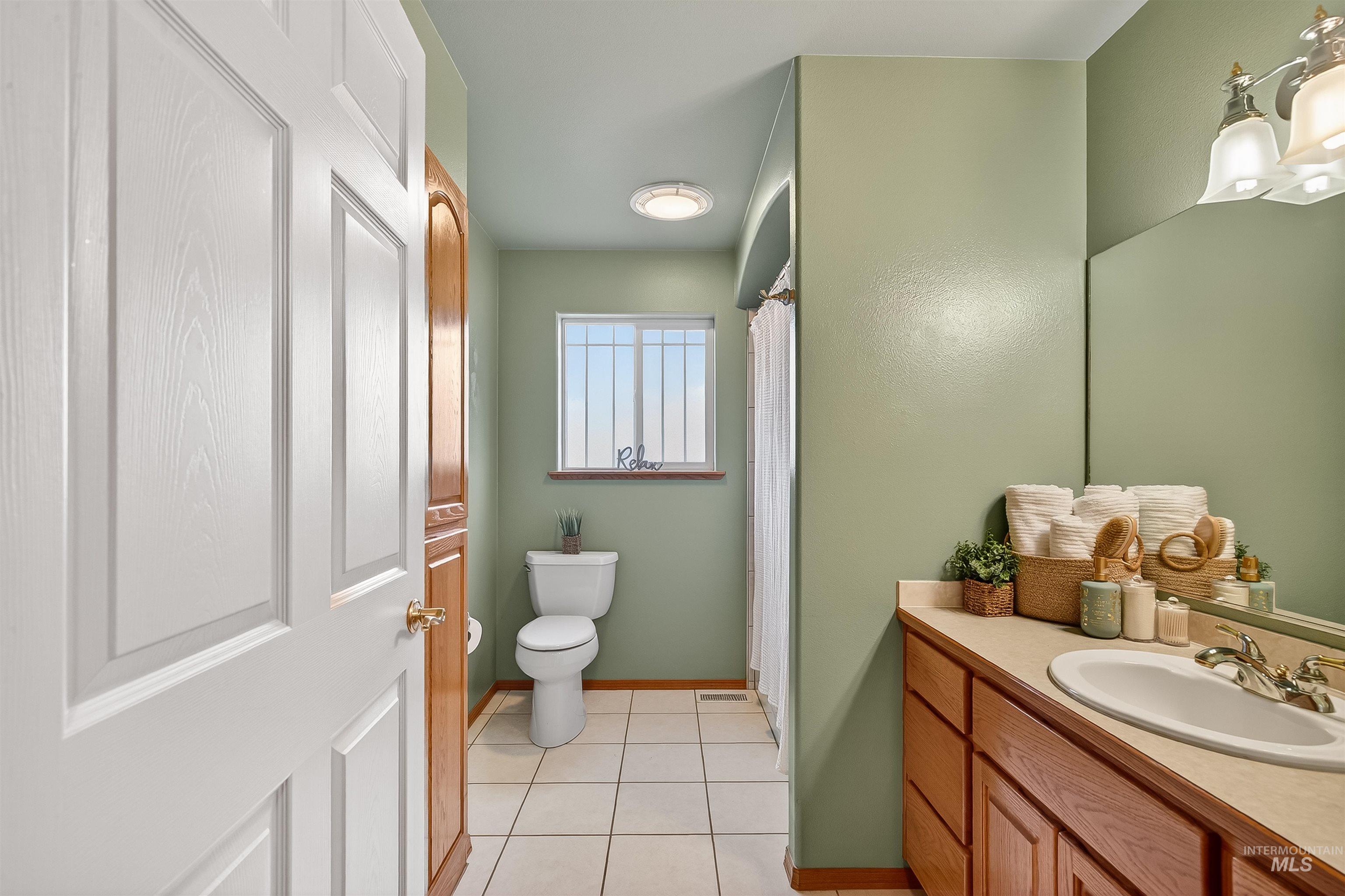 1324 Setlow Court Clarkston, WA 99403 - Photo 29 of 49 Full bathroom with a shower with shower curtain, vanity, and light tile patterned floors