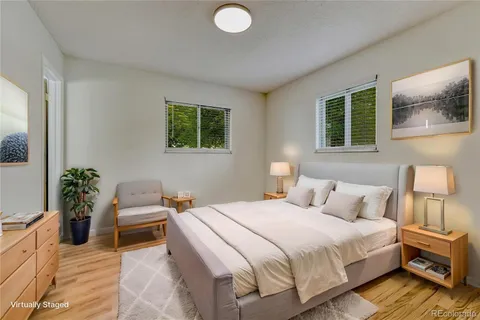 a bedroom with a bed and wooden floor