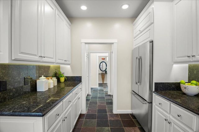 a kitchen with sink and cabinets