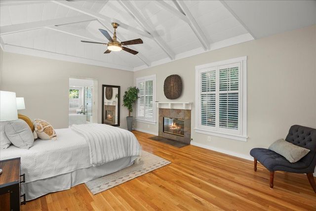 a bedroom with a bed and a fireplace