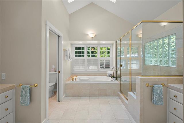 a spacious bathroom with a tub shower and sink