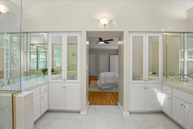 a bathroom with a tub sink and mirror
