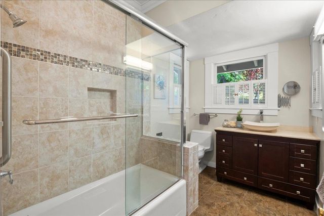 a bathroom with a tub sink shower and mirror