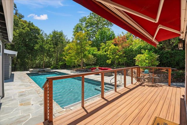 a view of balcony with wooden floor and seating space