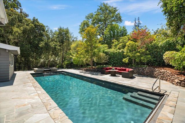 a view of a backyard with sitting area