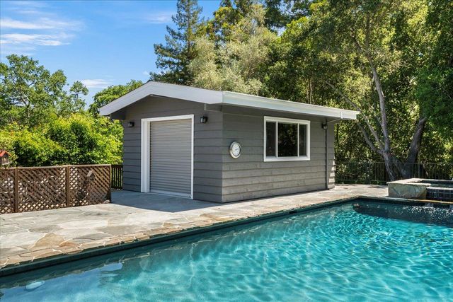 a view of house with backyard space and garden