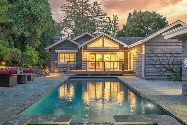 a view of swimming pool with outdoor seating and plants