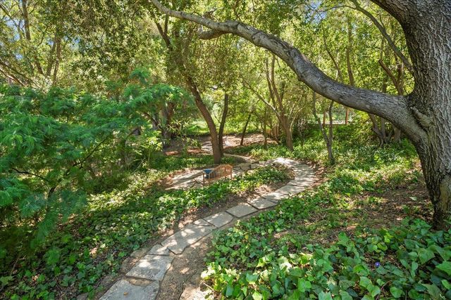 a backyard of a house with lots of green space and trees