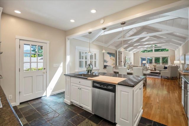 a kitchen that has a sink and a stove in it