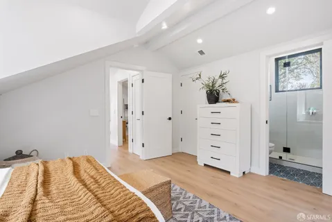 a bedroom with a bed and a dresser