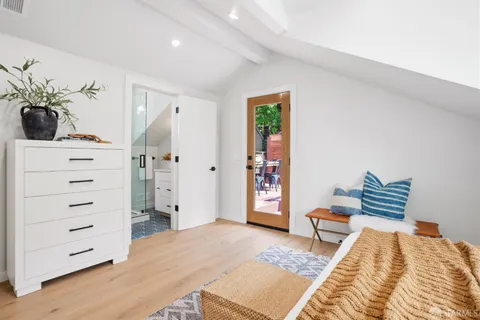 a bedroom with furniture and a window