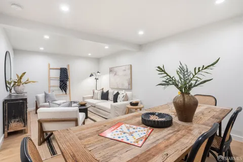 a living room with furniture potted plant and a table