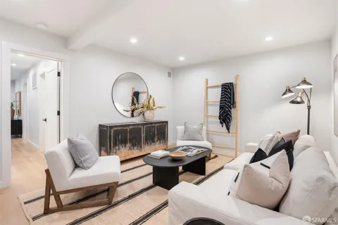 a living room with furniture a rug and a chandelier