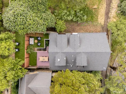 an aerial view of a house with a yard