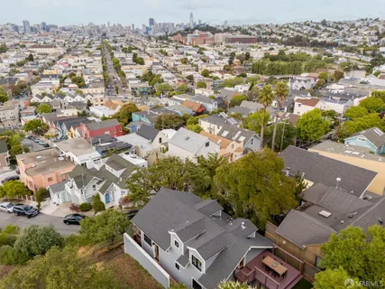 an aerial view of residential houses with outdoor space