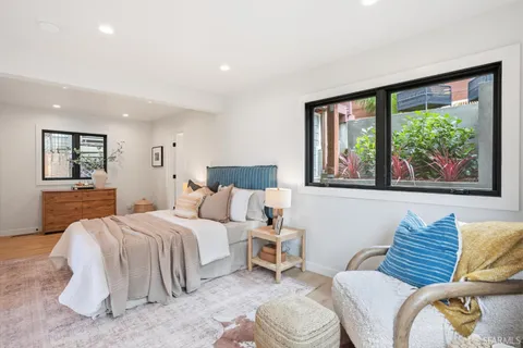 a bedroom with a bed and a couch