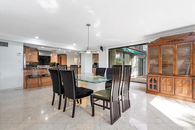 a large kitchen with stainless steel appliances granite countertop a stove a sink and a refrigerator