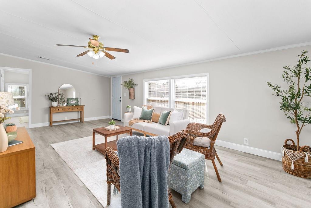 18137 Hollister Road Orlando, FL 32820 - Photo 5 of 27 a living room with furniture and wooden floor
