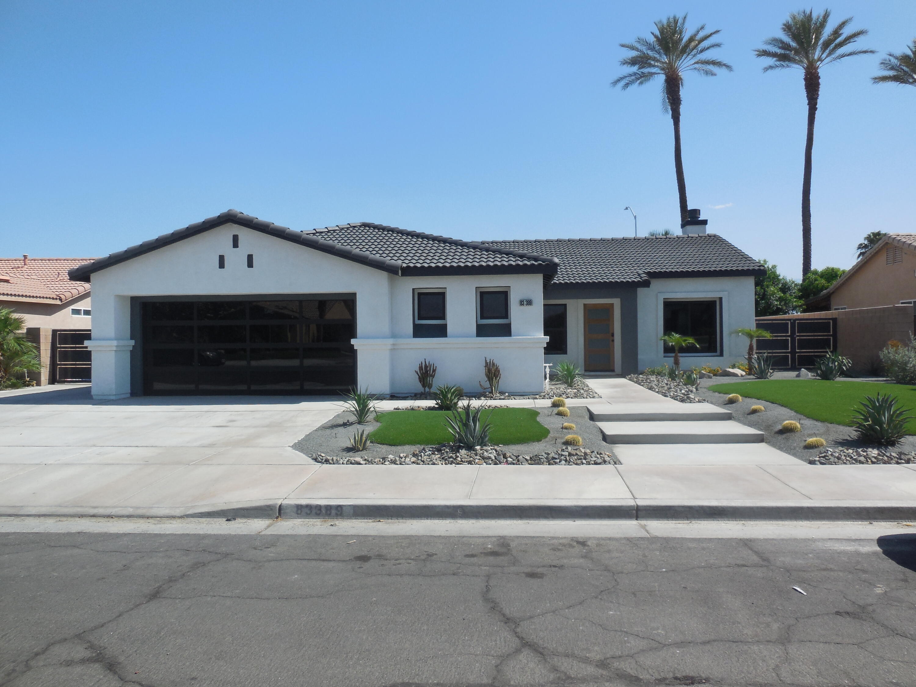 a front view of a house with a garden