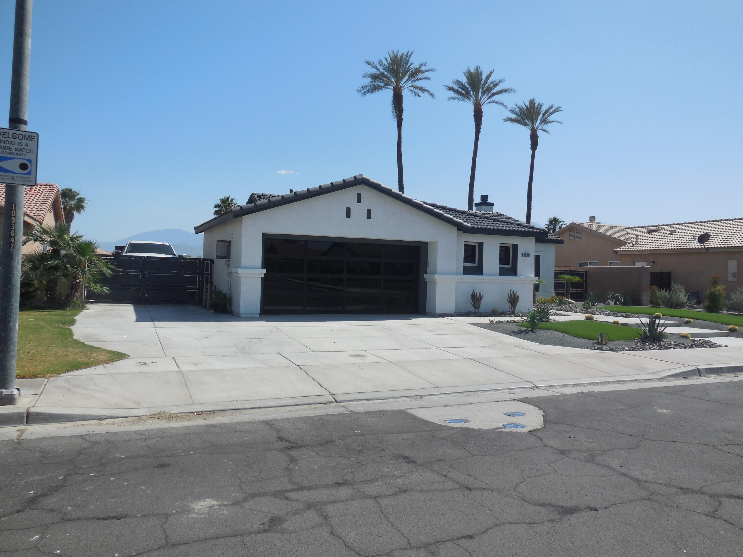 83389 Calypso Circle Indio, CA 92201 - Photo 3 of 45 a front view of a house with a yard and garage