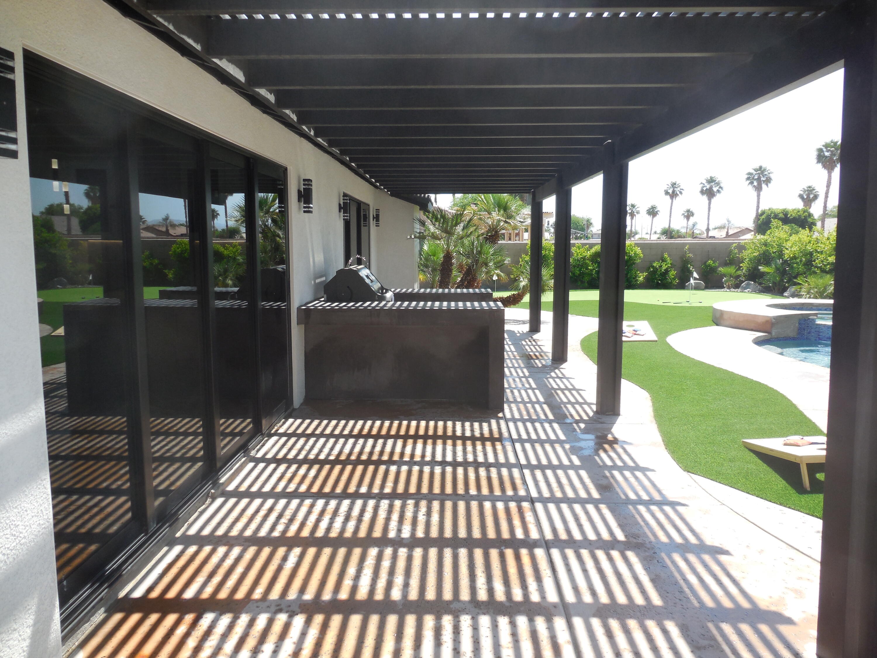 83389 Calypso Circle Indio, CA 92201 - Photo 33 of 45 a view of a patio with a table chairs and wooden floor