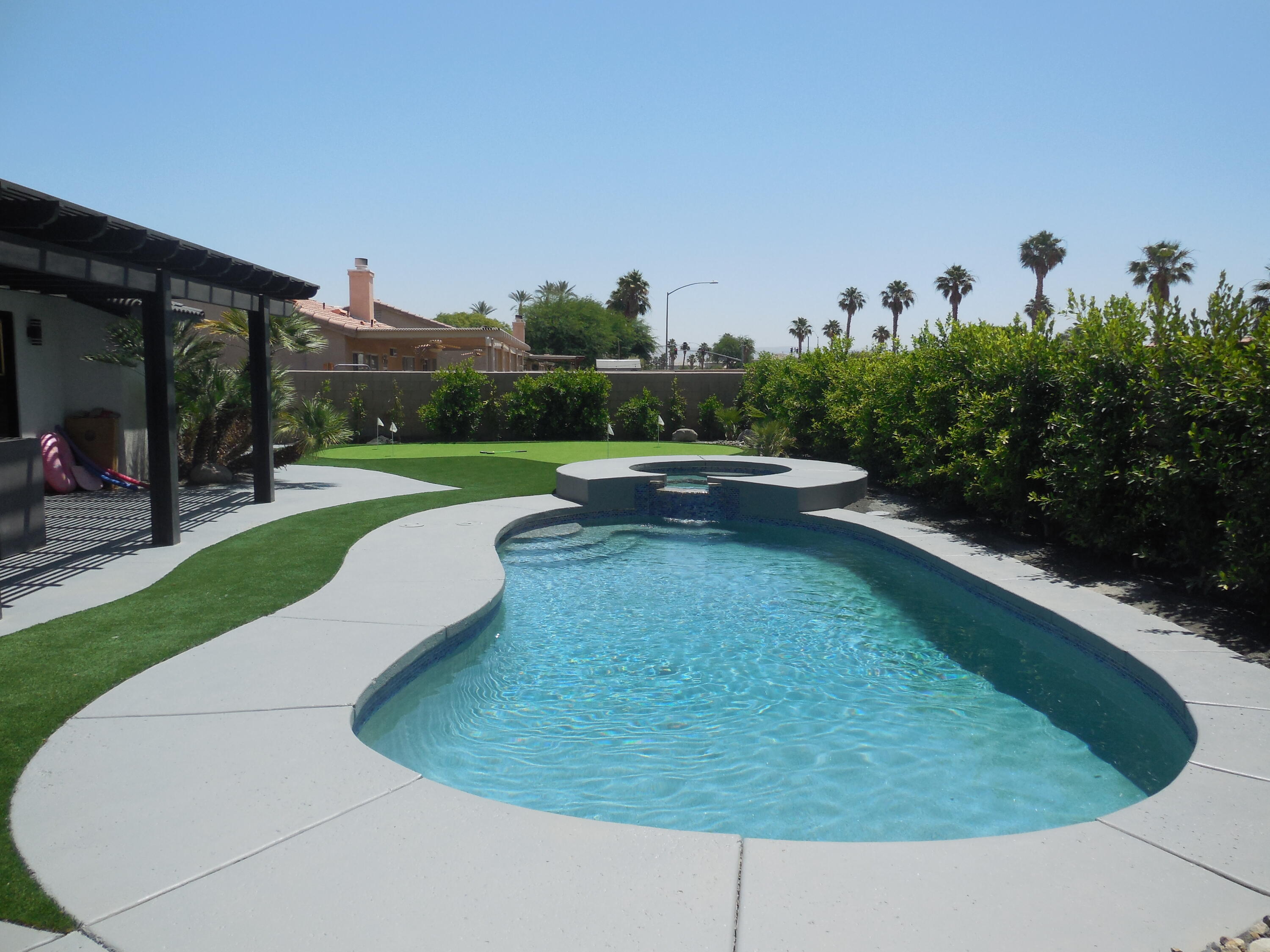 83389 Calypso Circle Indio, CA 92201 - Photo 4 of 45 a view of a swimming pool with a yard