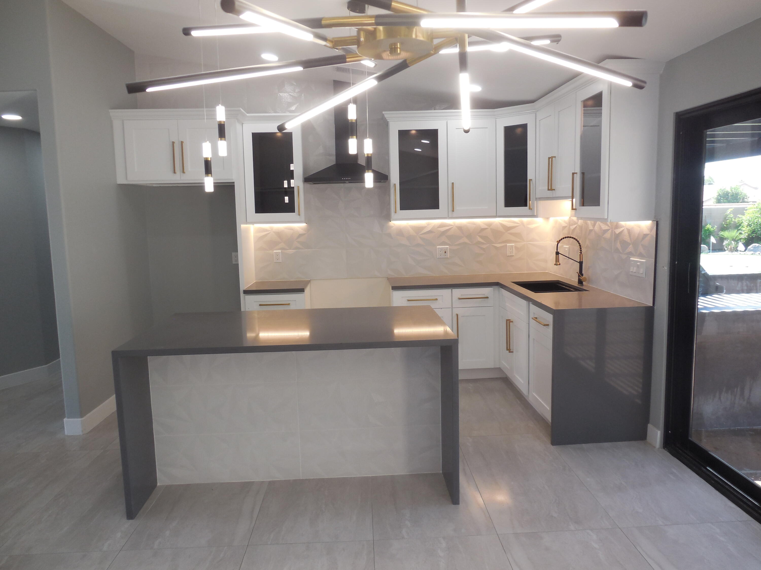 83389 Calypso Circle Indio, CA 92201 - Photo 9 of 45 a view of a kitchen with a sink and chandelier
