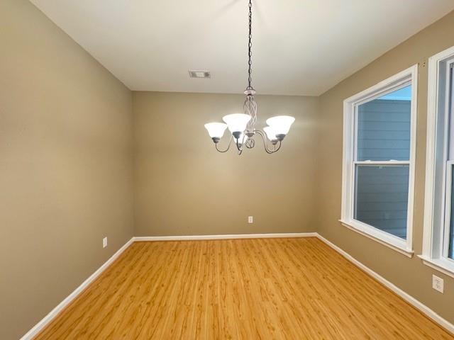 419 Grayson Way Alpharetta, GA 30004 - Photo 6 of 16 a view of empty room with wooden floor and chandelier