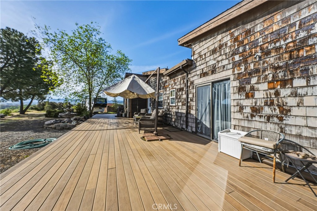 3245 Ackley Road Lakeport, CA 95453 - Photo 6 of 16 a view of a patio with couches and table and chairs with wooden floor and fence