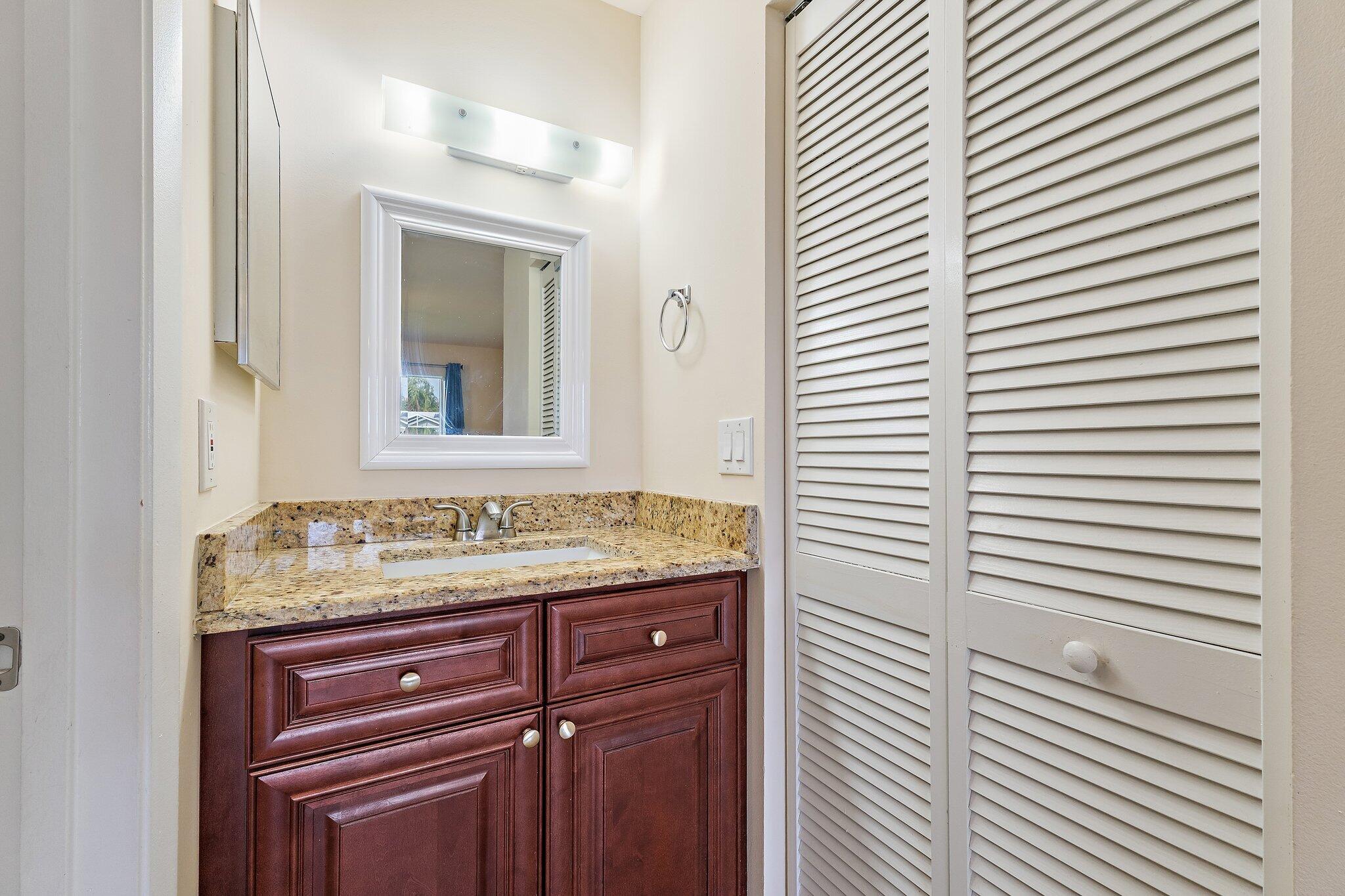 109 Doe Trail Jupiter, FL 33458 - Photo 13 of 26 a bathroom with a granite countertop sink and a mirror