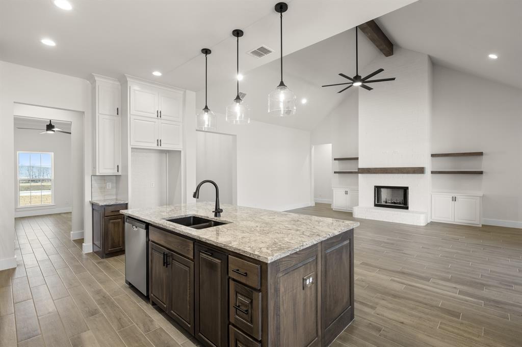 4867 Prairie Sky Lane DISH, TX 76247 - Photo 13 of 27 a kitchen with granite countertop a sink a counter space appliances and cabinets