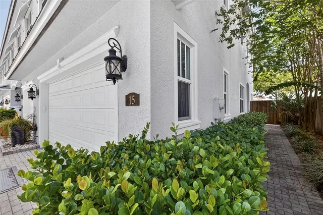 a vase of flowers sitting in front of a house