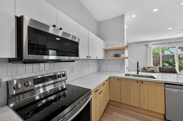 a kitchen with a sink stainless steel appliances and cabinets