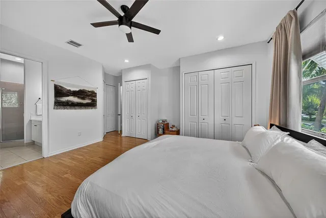 a bedroom with a large bed and a chandelier