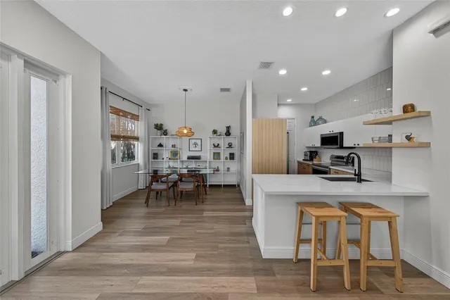 a large kitchen with lots of counter space and furniture