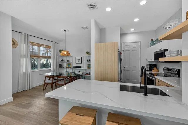 a kitchen with stainless steel appliances a refrigerator and wooden cabinets
