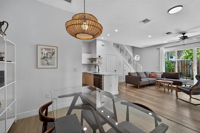 a living room with furniture a chandelier and a large window