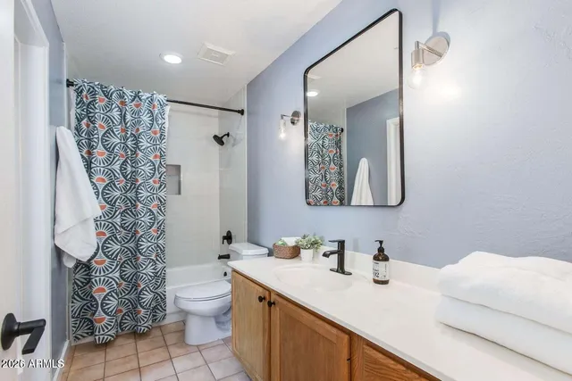 a bed room with a bed and a night stand