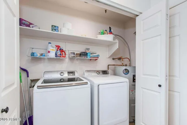 a view of a kitchen with kitchen island and stainless steel appliances