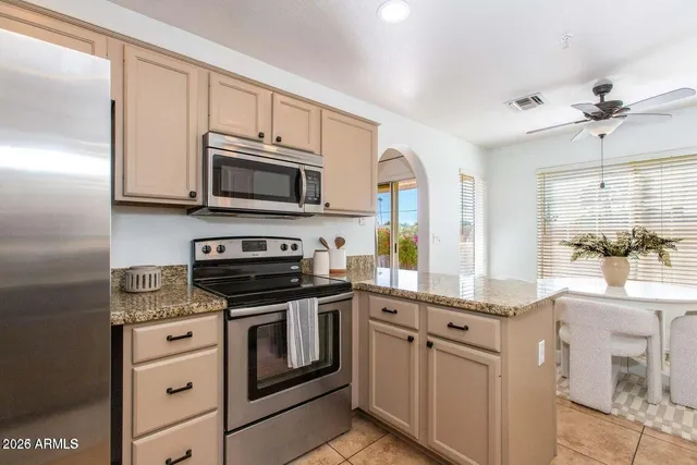 a large kitchen with stainless steel appliances lots of counter top space
