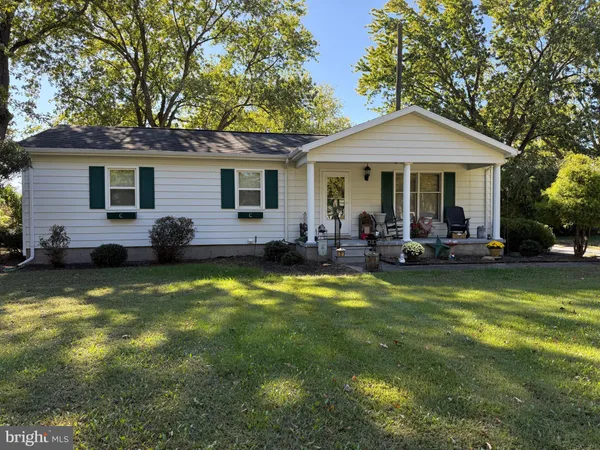 a view of a house with swimming pool and a yard