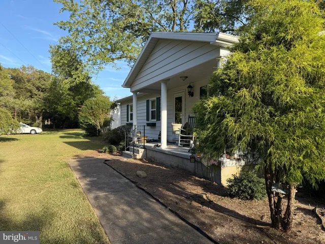 a front view of a house with yard and green space
