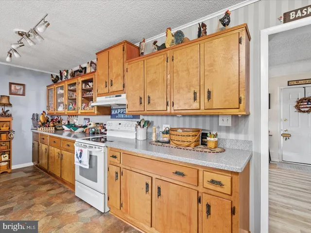a kitchen with stainless steel appliances granite countertop a sink and cabinets