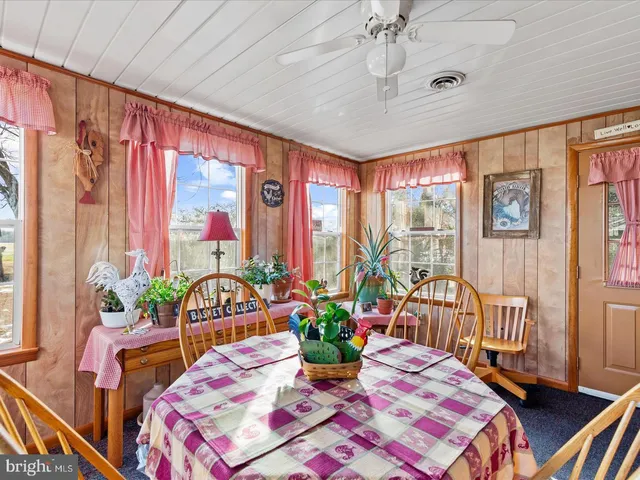 a bedroom with furniture and a large window