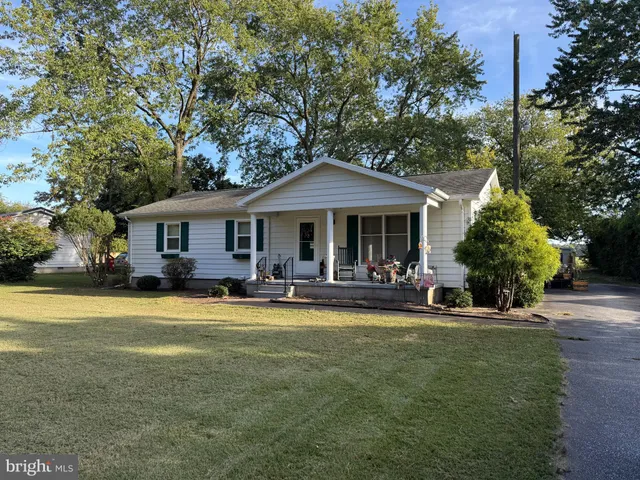 a front view of a house with swimming pool having outdoor seating