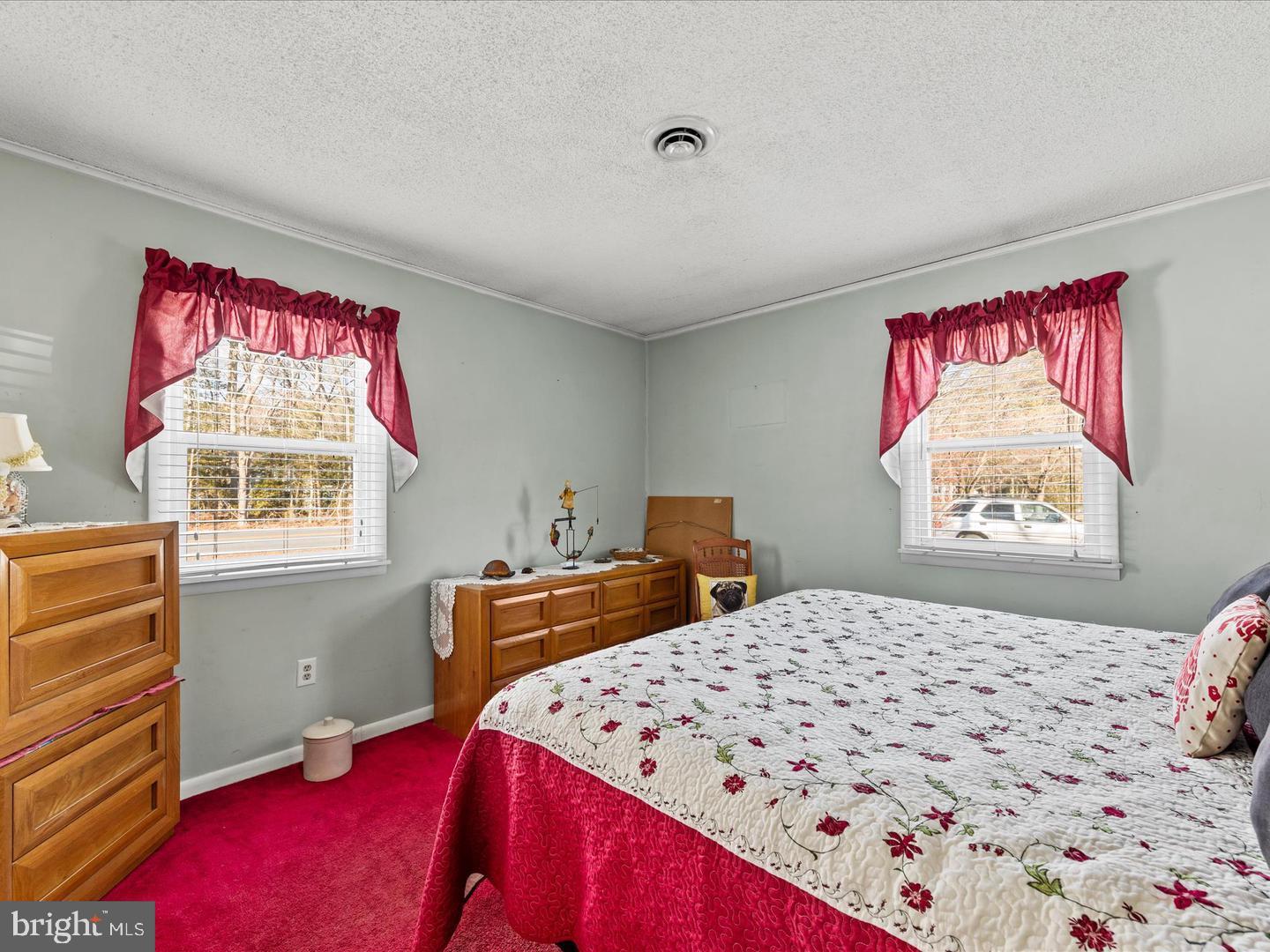 7132 Airport Road Laurel, DE 19956 - Photo 33 of 37 a bedroom with a bed and a dresser with painted walls