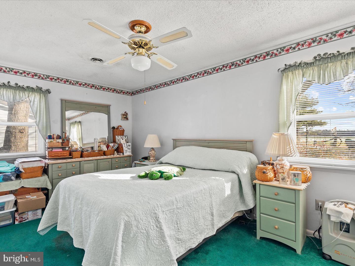 7132 Airport Road Laurel, DE 19956 - Photo 35 of 37 a bedroom with a bed and a chandelier