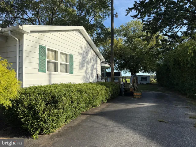a view of a house with a yard and plants